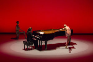 Dancers around piano